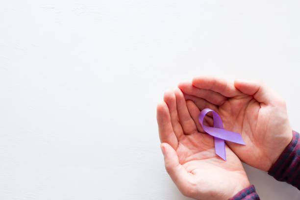 istock man holding a purple ribbon on a white background with space for text 998688568