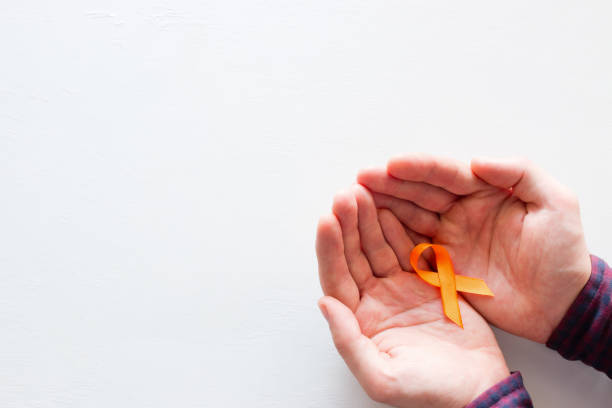 istock man holds an orange ribbon on a white background with space for text 998688582