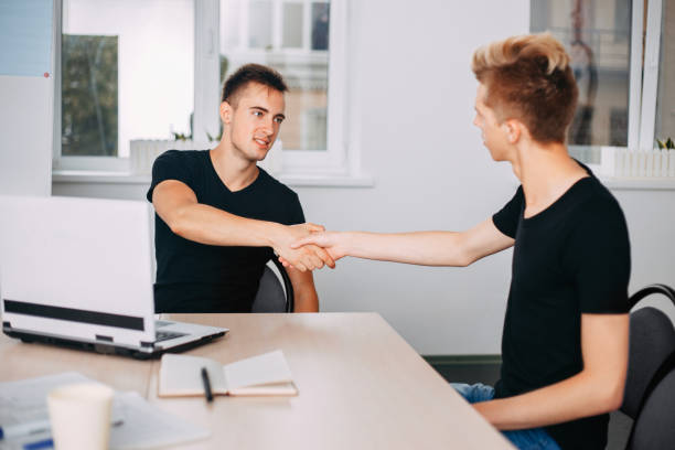 istock Young men shaking hands hiring new team member 998688586