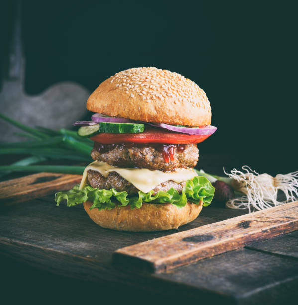 istock cheeseburger on a brown wooden board 998689184