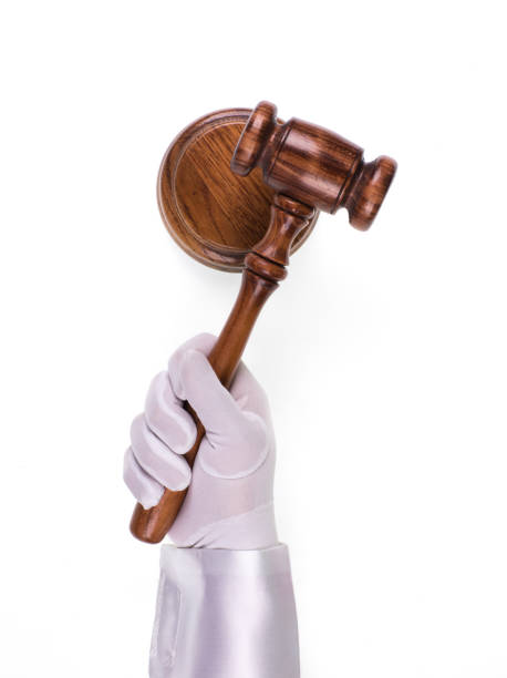 istock judicial hammer in hand on a white background 998691644