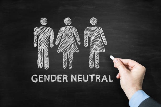 Gender neutral Man drawing the Gender neutral sign on wblackboard role reversal stock pictures, royalty-free photos & images