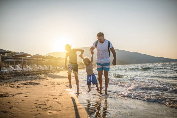istock Father with kids at the beach 998703660