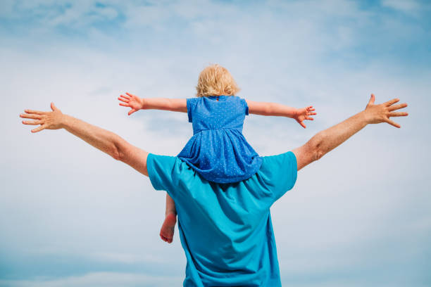 istock father and little daughter play at sky 998703706