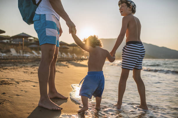 istock Father with kids at the beach 998705822