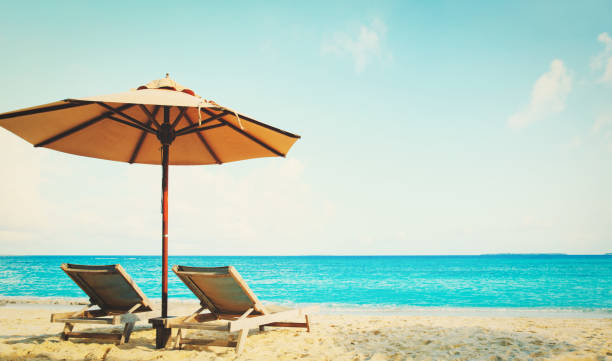 istock Two beach chairs on tropical vacation 998707128
