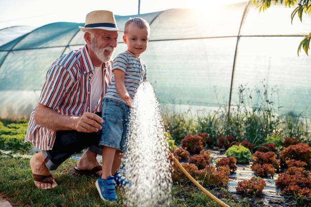 istock Grandfather and grandson in garden 998715436