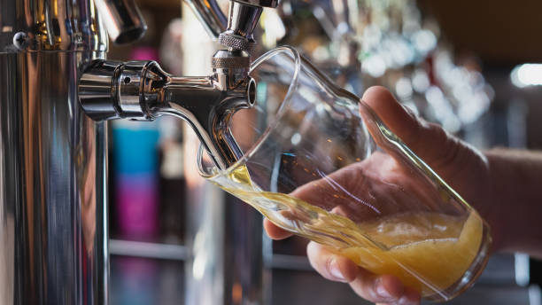 istock Bartender pouring a beer from the tap 998715732