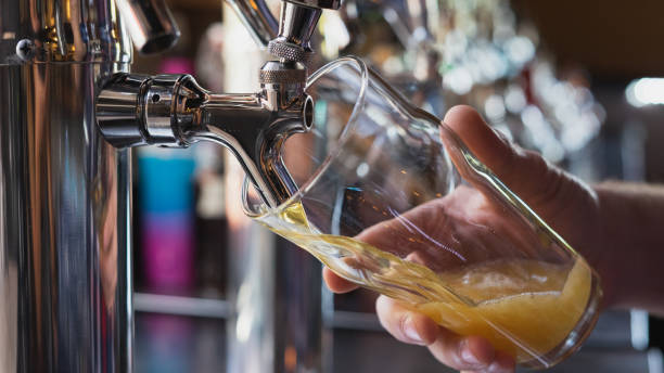 Bartender pouring a beer from the tap Tap beer, pouring a beer craft beer photos stock pictures, royalty-free photos & images