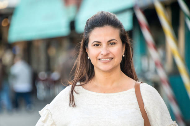 Smiling mature woman posing looking at the camera Smiling hispanic or middle eastern mature woman posing looking at the camera older woman purse stock pictures, royalty-free photos & images