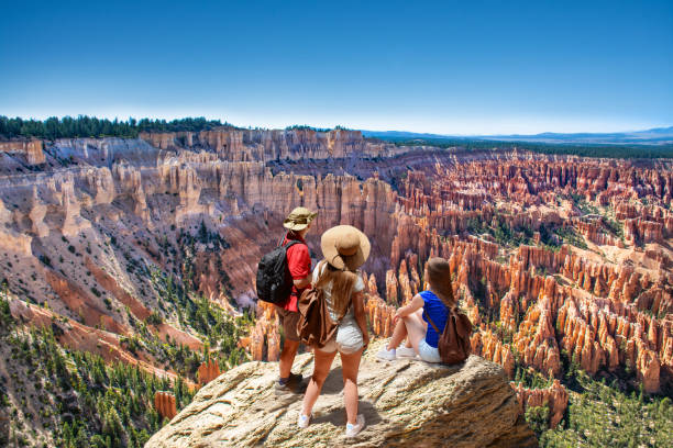 Family on top of  mountain enjoying time together, looking at beautiful view. People on  hiking trip. Family on top of  mountain enjoying time together, looking at beautiful view. Inspiration Point, Bryce Canyon National Park, Utah, USA bryce canyon stock pictures, royalty-free photos & images