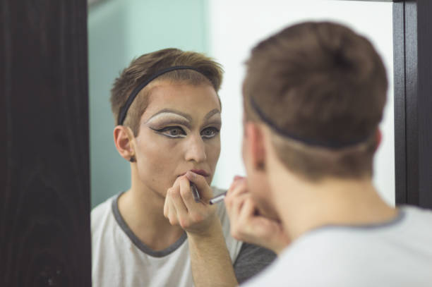istock Man gets dressed in drag attire in bathroom 998732596