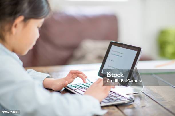 Completing A Project Stock Photo - Download Image Now - Child, Student, Technology