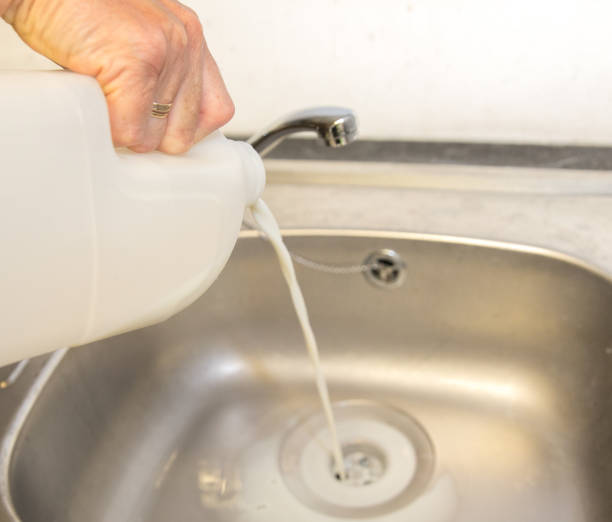 istock Fresh milk being poured down a stainless steel sink, waste 998743416