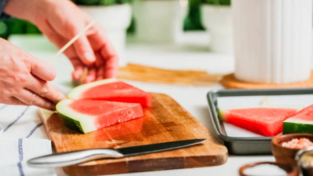 istock Sliding the wood pop stick into the watermelon wage wedge 998751234