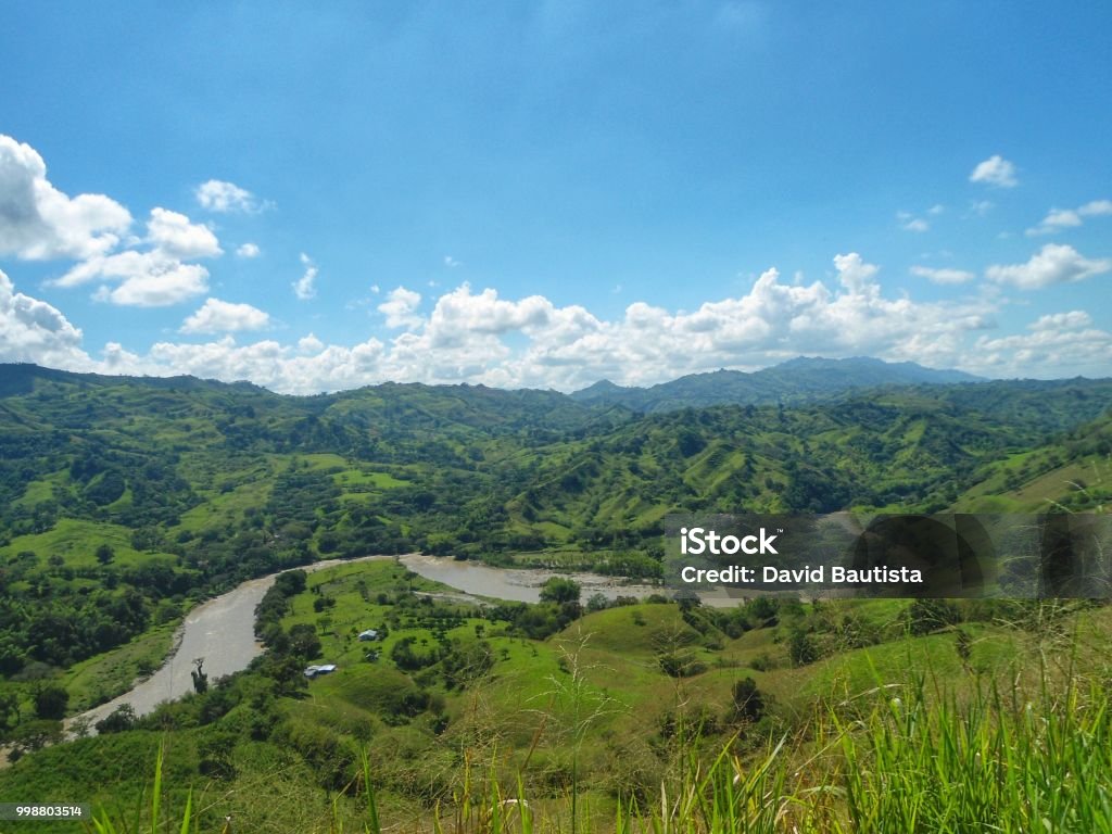 Impressive view of the Cauca river, its valley and the mountains of Colombia Impressive panoramic view of the Cauca River and the valley that forms between the Central and Western Cordilleras of the Andes. Wonderful river that crosses Colombia from south to north. Colombia Stock Photo
