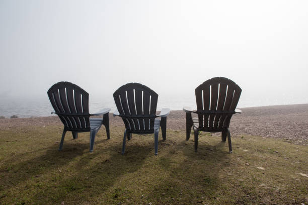 istock Three Chairs over looking Foggy Lake 998813308