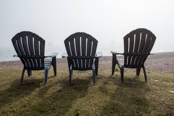 istock Three Chairs over looking Foggy Lake 998813312