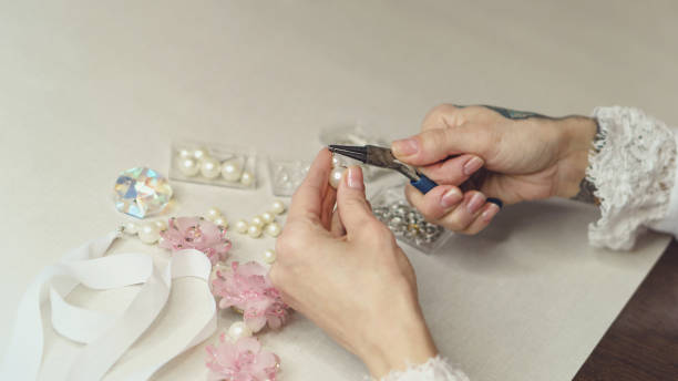 istock Girl is making jewelry 998832060