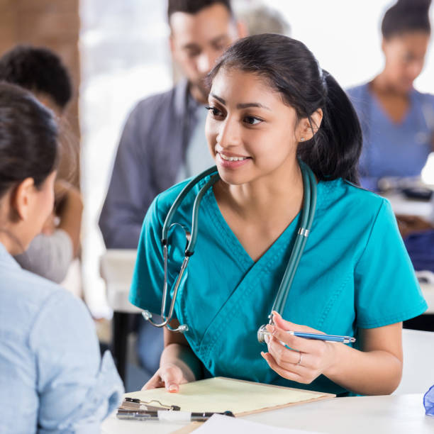 istock Volunteer doctor discusses patient's symptoms 998833416