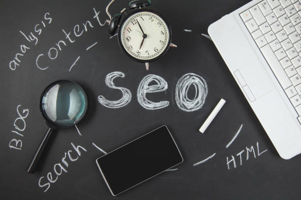 istock SEO Search engine optimization concept Magnifying glass, clock, smartphone on a black background with an inscription SEO 998836500