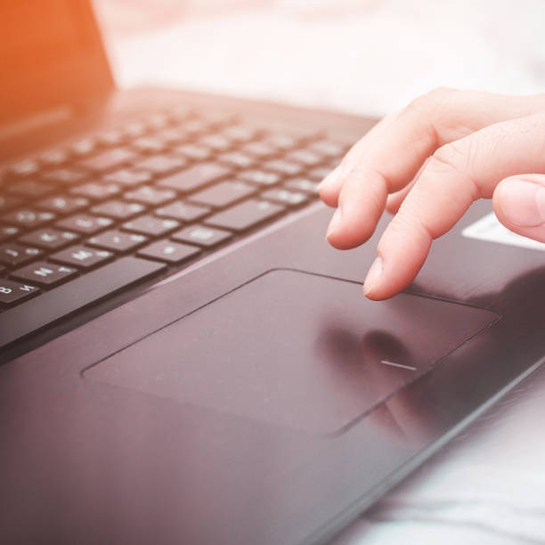 istock female hand on a laptop, touchpad. work at the computer. notebooks 998852046