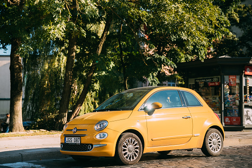 Vilnius, Lithuania - September 29, 2017: Side View Of Yellow Color Fiat 500 Car Parking On Street