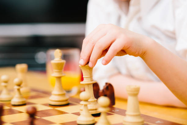 istock Midsection Of Woman Playing Chess 998855504
