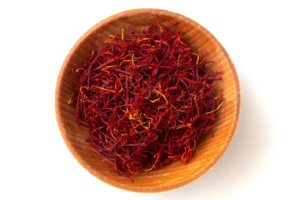 Mancha Saffron Small bowl of Mancha Saffron from above on white background saffron stock pictures, royalty-free photos & images
