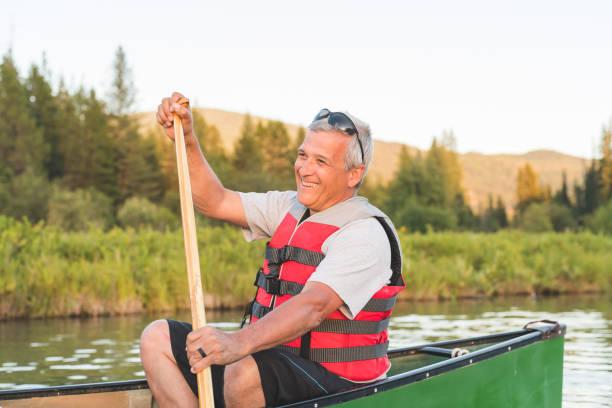 istock Senior male canoeing on a lake 998858864