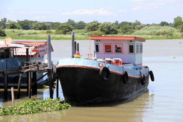 istock Boat medium landing at the small boat dock in Chao Phraya River, Thailand. 998878358