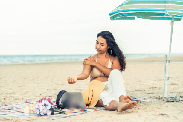 istock Plus size young woman sitting on the beach. 998885170