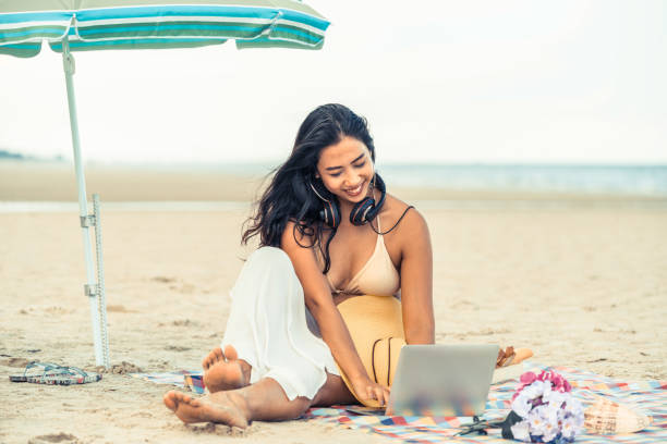 istock Plus size young woman sitting on the beach. 998885172