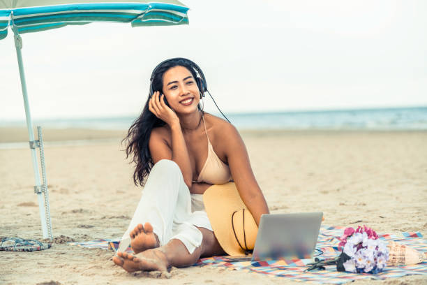 istock Plus size young woman sitting on the beach. 998885190