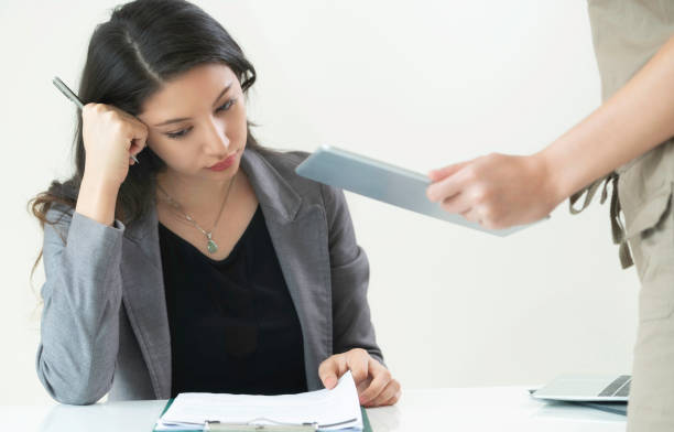 istock Businesswoman reads and talks with partner. 998885484