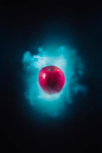high contrast image of a poisoned apple on a black background