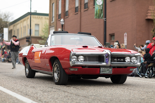 Holland, Michigan, USA - May 12, 2018 A red Pontiac GTO classic muscle car at the Muziek Parade, during the Tulip Time Festival