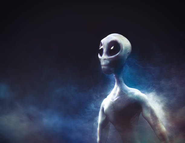 istock Alien on a smoky background / 3D illustration 998889392
