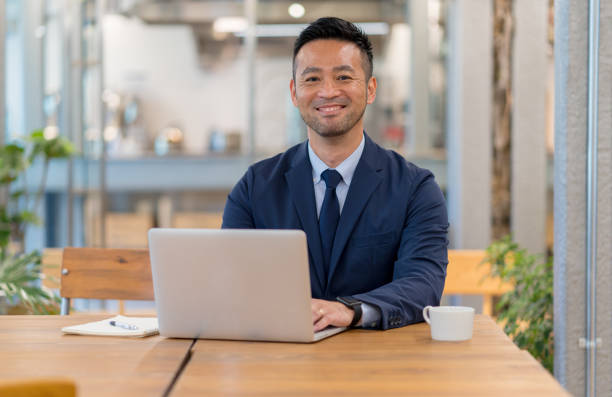istock Portrait of a confident businessman using a computer in an office 998891916