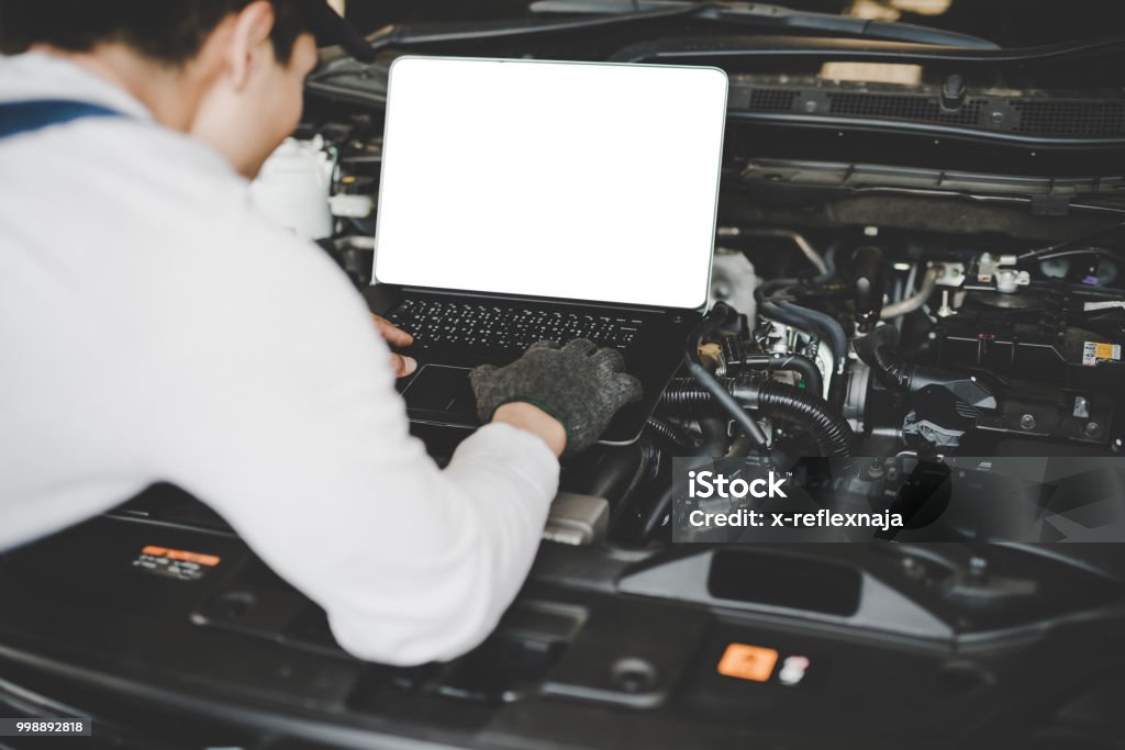 Mecanic Working Computer Young Men Mechanic Working On A Computer Connected To A Car Engine ...