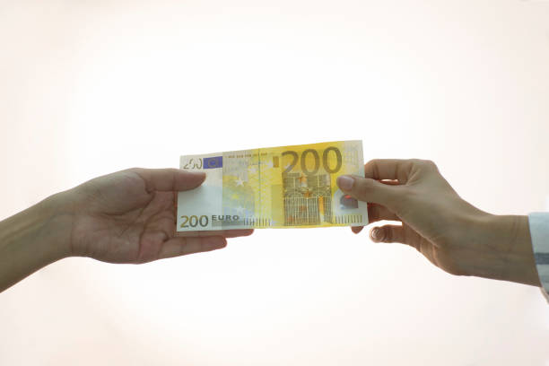 istock people making money transaction, dollars, euros 998892858