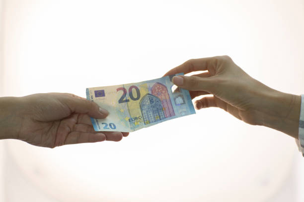 istock people making money transaction, dollars, euros 998892902