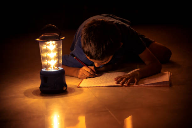 istock 7 years Indian Boy studying under lamp 998926074