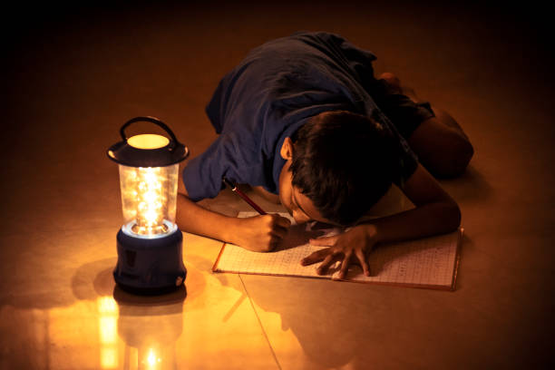 istock 7 years Indian Boy studying under lamp 998926080