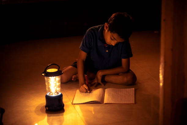 istock 7 years Indian Boy studying under lamp 998926084