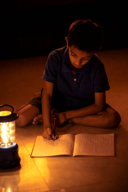 istock 7 years Indian Boy studying under lamp 998926128
