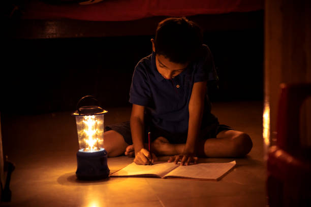 istock 7 years Indian Boy studying under lamp 998926142