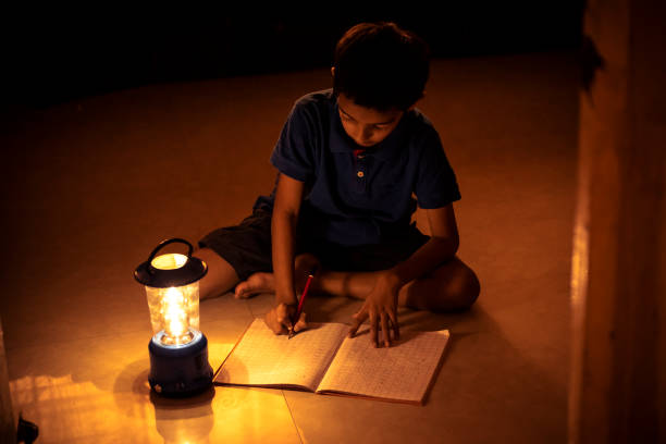 istock 7 years Indian Boy studying under lamp 998926146