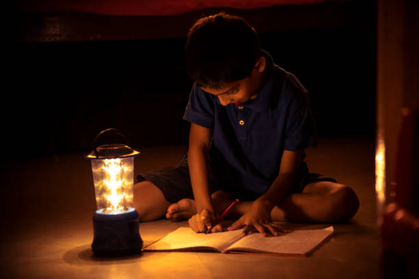 istock 7 years Indian Boy studying under lamp 998926166