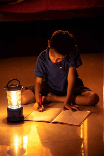 istock 7 years Indian Boy studying under lamp 998926174